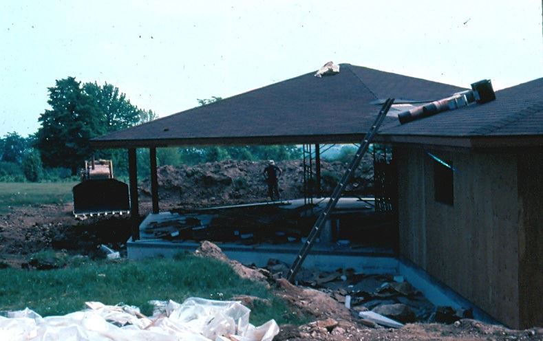 A partially built hexagonal building with a roof but no walls